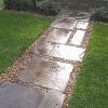Turfed lawn with gravel and paved path
