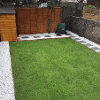 Newly laid lawn with gravel and paving path around the edge