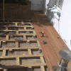 New decking being laid showing raised structure below decking planks