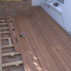 New decking being laid showing raised structure below decking planks