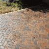 The finished brickwork patio with a curved step down to the lawn