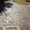The finished brickwork patio with a curved step down to the lawn