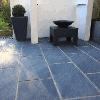The finished patio with rectangular black/grey granite style paving slabs