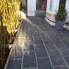 The finished patio with rectangular black/grey granite style paving slabs