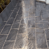 The finished patio with rectangular black/grey granite style paving slabs