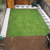 Newly laid lawn with gravel and paving path around the edge